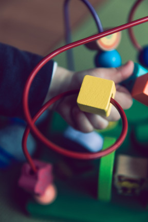 A toddler playing with an activity toy